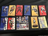 Full view of 180 cards in multiple stacks showing front card designs with various players in team uniforms and bold colors.