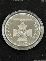 Obverse of coin showing the Victoria Cross medal design with inscriptions CANADA, DOLLAR, and year 2006.