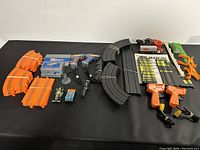 Close-up photo of orange track pieces with controllers, control box, and slot cars