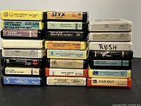 Front view of stacked 8-track tapes showing titles and labels