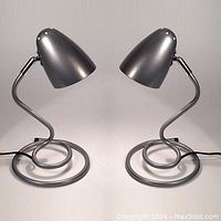 Pair of 1990s spiral base metal desk lamps in pewter color, front view showing both lamps facing each other