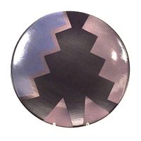 Top view of the circular pottery charger plate showing geometric postmodern design in black and purple shades with glossy glaze finish.