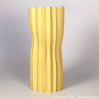 Front view of matte pale yellow green pleated porcelain vase