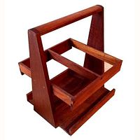 Photo of a vintage 1960s teak wood wine bottle carrier with a handle and four bottle compartments, showing the wood grain and mid-century style geometry.