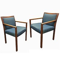 Front and side view of the pair of mid-century walnut framed armchairs with blue upholstered seats and backs.