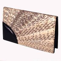 Front view of vintage snakeskin clutch showing quilted snakeskin leather with a black leather accent on front corner.