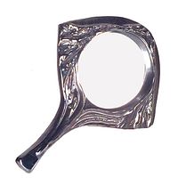 Image of the vintage hand mirror showing silver glazed deeply textured ceramic frame and handle with circular mirror surface.