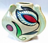 Front view of a light green crackled glaze mid-century asymmetrical vase showing hand painted abstract floral design in red, green, blue and black.