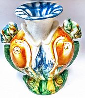 Front view of the vintage hand painted art pottery vase showing colorful raised details and blue flared rim.