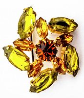 Clear image of the rhinestone brooch showing yellow and amber marquise stones with central dark orange round stone in gold-tone setting.
