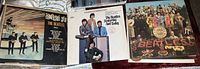 Photo showing the three Beatles vinyl record covers: 'Something New', 'Yesterday And Today', and 'Sgt. Pepper's Lonely Hearts Club Band'