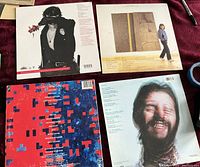 Four LP record back covers showing album artwork and track listings.