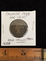 Front view of the 1888 Canadian one cent coin mounted on card showing date, queen's profile, and hole drilled through