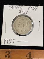 Obverse side of the 1937 Canadian 25 cents silver coin showing King George VI's portrait and inscriptions.