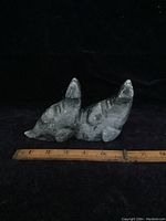 Front side view of the double seal soapstone carving showing the full length of the piece with ruler for scale.