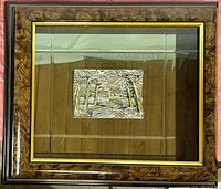 Framed embossed landscape artwork showcasing the full piece inside glass with wooden outer frame and gold trim.