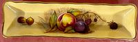 Full view of rectangular bone china tray with fruit design and gold trim.