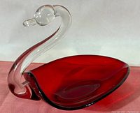 Side angle of Duncan Miller Pall Mall ruby red swan candy dish with clear crystal neck showing the elegant curve of the neck and rich ruby red color body.