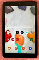 Front screen of Samsung Galaxy Tab A showing home screen with apps and colorful wallpaper.