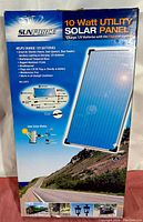 Front view of the Sunforce 10 watt utility solar panel box showing product name, photo of the panel, and selling points.