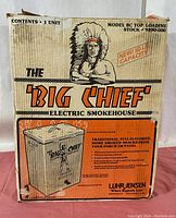 Close-up of Big Chief Electric Smokehouse box front showing model details, capacity, and vintage Native American chief artwork