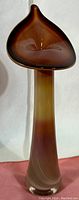 Front angled view of the elongated Jack in the Pulpit style glass vase, showing color gradient from light amber base to dark brown top.