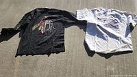 Both vintage Ben Folds concert t-shirts laid out flat, showing different graphics on front