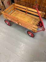 Side angle shot of the antique wooden wagon showing 'Super Express' branding and red metal wheels.