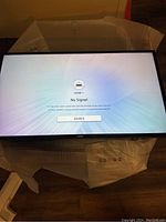 Unboxed TV powered on showing "No Signal HDMI1" message
