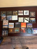 Photo showing 22 music CDs with covers from bands like Led Zeppelin, Pink Floyd, Vangelis, The Who, and more.