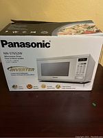 Sealed Panasonic NN-ST652W microwave oven box showing model number, capacity and power information.