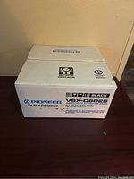 Front view of the unopened original box showing Pioneer branding and model VSX-D602S