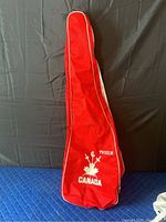 Red Prieur Canada carrying bag with white piping and printed logo including crossed swords and maple leaf