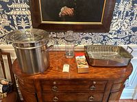 Overall view of pot, lid, steamer insert, lantern, boxed item, and roasting pan