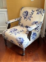 Front angle view of armchair and pillow showing floral pattern on seat and back