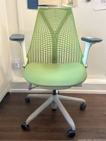 Front view of chair showing mesh back, seat upholstery and caster base