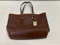 Front view of brown leather tote handbag