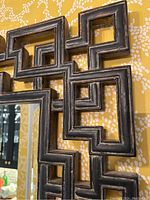 Close-up of upper left section of geometric lattice wood frame