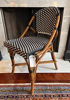 Front three-quarter view of chair showing frame and woven seat