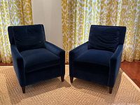Front-angle view of both chairs side by side showing overall design, color and condition