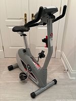 Side view of Schwinn stationary exercise bike showing seat, pedals, and digital display console