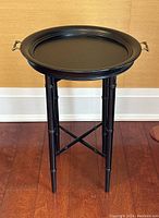 Full view of the vintage style black folding tray side table with tray on top and bamboo style tripod legs