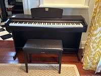 Front view of piano with music rest and bench