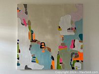 Front view of abstract painting on square canvas displaying full color composition