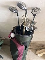 Photo showing Spaulding Pro Response golf clubs including driver, 3-wood, irons, and the golf bag with attached accessories.