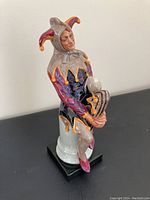 Front left angle of the Royal Doulton jester figurine showing the detailed costume and face.