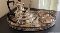 Full set on tray featuring coffee pot, tea pot, creamer, sugar bowl
