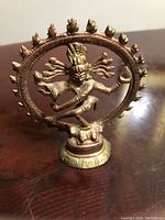 Front view of Shiva Nataraja statue showing intricate arms and halo details