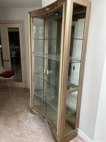 Front view of closed cabinet showing concave front design and carved detailing