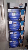 Photo of stacked boxes of Kirkland men's protective underwear, showing quantity and packaging details